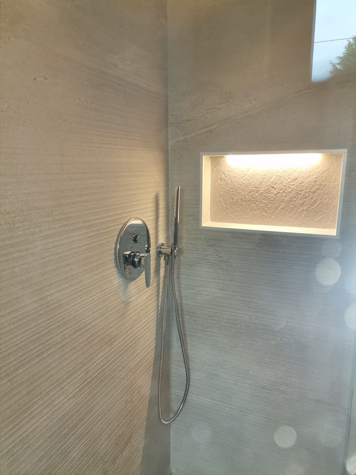 Doccia con nicchia illuminata a LED e rivestimento in grande formato
