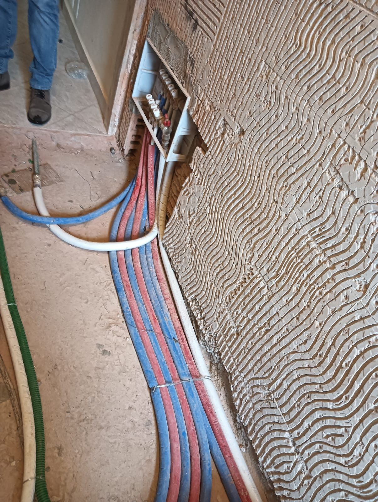 Corrugati elettrici e tubazioni idriche posati a pavimento durante il cantiere